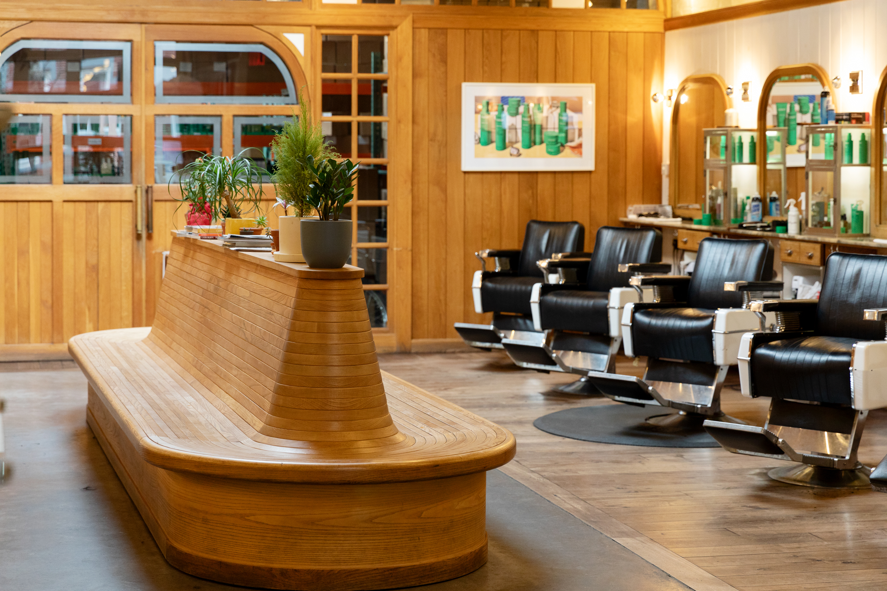 The Williamsburg floor — bench, chairs, and the product case