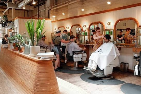 Barbers at work along the mirror row
